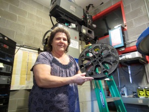 Edie Rollings holds a 35mm film reel in the projection room at the Ritz Theater in Thermopolis.